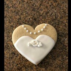 a heart shaped cookie with pearls on it