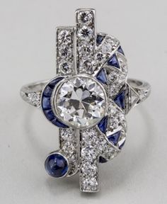 "𝐃𝐞𝐬𝐜𝐫𝐢𝐩𝐭𝐢𝐨𝐧 : *Antique Old European Cut Diamond Woman's Ring, Vintage Sapphire Diamond Ring, Edwardian Art Deco Ring, 925 Silver Wedding Ring, Fine Jewelry. ❖ 𝐃𝐢𝐚𝐦𝐨𝐧𝐝 𝐃𝐞𝐭𝐚𝐢𝐥𝐬 *Color : White, Blue *Clarity : VVS *Cut : Excellent *Center Stone Shape : Old European Cut *Center Stone Size : 7.00 MM *Center Stone Weight : 1.33 CT *Type : Cubic Zirconia (CZ) *We have all types of fancy & color Gemstone. For more queries please contact us immediately. ❖ 𝐑𝐢𝐧𝐠 𝐃𝐞𝐭𝐚𝐢𝐥𝐬 Luxury Sapphire Art Deco Jewelry, White Sapphire Multi-stone Diamond Ring, Art Deco Multi-stone Diamond Ring, Art Deco Sapphire Diamond Promise Ring, White Diamond Gemstone Ring In Art Deco Style, Exquisite Multi-stone Platinum Diamond Ring, Exquisite Multi-stone Diamond Ring In Platinum, White Gold Sapphire Crystal Wedding Ring, Art Deco Platinum Ring Jewelry