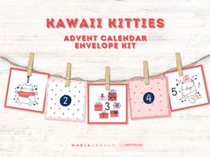 the kawaii kitties calendar is hanging on a clothes line with four cards attached to it