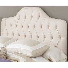 an upholstered headboard with buttons on it