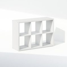 a white book shelf with four sections on one side and three smaller ones on the other