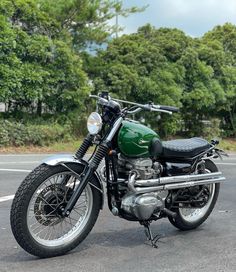 a green motorcycle is parked on the street