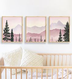 three paintings on the wall above a crib