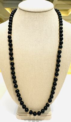 Enchanting vintage 1970s beaded necklace! This elegant necklace features 10mm, natural, hand tied, onyx beads, accented by eight 7.7mm, solid 14k yellow gold beads. The necklace is substantial, weighing 78 grams! It is 27 inches long. This gorgeous necklace is in excellent condition! Elegant Necklace, Onyx Bead, Elegant Necklaces, Gorgeous Necklaces, Vintage 1970s, Gold Beads, Onyx, 1970s, Etsy Accessories