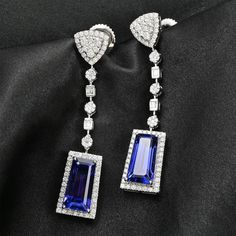 Styled with clean lines and symmetry, these limited-edition tanzanite earrings in 950 platinum resonate with iconic jewelry brands. Showcasing rare tanzanite gems of a unique taper baguette shape, these earrings are studded with top-quality diamonds for a sparkling contrast. These collectible earrings have an unmatched value for high-end jewelry connoisseurs. Luxury Tanzanite White Gold Earrings, Luxury White Gold Tanzanite Earrings, Luxury Tanzanite Earrings, Luxury Tanzanite Drop Earrings, Elegant Tanzanite Formal Earrings, Elegant Tanzanite Earrings For Formal Occasions, Formal Tanzanite Earrings In Fine Jewelry Style, Modern Sapphire Earrings For Formal Occasions, Iconic Jewelry