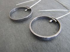 "Here are some simple affordable silver earrings that are easy to wear every day. These earrings are textured on the surface, formed into a circle, pierced, oxidized, buffed, and suspended from handmade polished sterling silver ear wires. The circle is about 1\" in diameter (25mm)" Disk Earrings, Silver Circle Earrings, Creative Jewelry Photography, Handmade Silver Jewellery, Geode Earrings, Lace Earrings, Silver Jewelry Design, Silver Earrings Handmade, Disc Earrings