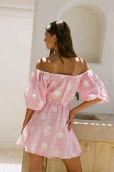 Obsessing over the ultra feminine Hiroki Dress, made from a seersucker pink and white gingham fabric with white flower embroidery! It is an off shoulder style featuring bold short puff sleeves, cutout at waist, ties at neckline and waist, covered button details at centre front and a relaxed mini skirt. Add a backpack and sandals or dress it up with the Strappy Rafaela Heels! Designed exclusively by Sabo. White Flower Embroidery, Ultra Feminine, Gingham Fabric, Off Shoulder Fashion, Sabo Skirt, Art Dress, Arte Floral, Gingham Dress, Flower Embroidery