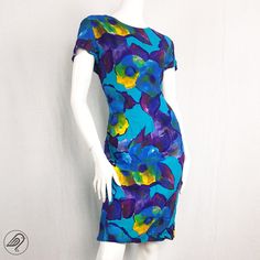 "Vintage 90s dress with a watercolour floral print in tropical neons, pencil fit. Labelled Size 12 but closer to a 10 in modern UK sizing; * Underarm to underarm 19\" * Across the waist at narrowest 16\" * Across hips 19\" * Length from shoulder to hem 40\"." Printed Fitted Tropical Dress, Fitted Tropical Printed Dress, Fitted Tropical Dress With Vibrant Print, Fitted Tropical Dresses With Vibrant Print, Colorful Fitted Printed Dresses, Blue Fitted Tropical Dress, Fitted Tropical Dress With Floral Print, Vibrant Fitted Dress With Short Sleeves, Fitted Tropical Print Short Sleeve Dresses