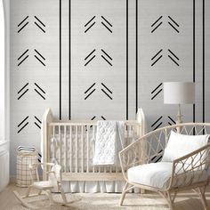 a baby's room with white furniture and black lines on the wall behind it