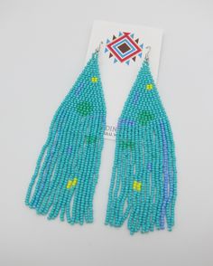 Amazing Modern Powwow Native American Style Boho Seed Bead Earrings with a variety of native colors in a modern non-traditional design. Stainless steel ear wires and genuine high quality beads. A beautiful combination of colors and native design at a super price. At nearly 6 inches in total length these are just amazing. Great to wear alone or to match with your dancing regalia. Cool modern look with a traditional flair. All handmade. Shipped Free to your home or office from Hawaii. Aloha! Traditional Turquoise Beaded Earrings For Festivals, Southwestern Style Green Earrings With Colorful Beads, Southwestern Green Earrings With Colorful Beads, Festival Turquoise Beaded Fringe Earrings, Southwestern Blue Beaded Fringe Earrings, Blue Southwestern Beaded Fringe Earrings, Southwestern Green Beaded Dangling Earrings, Multicolor Hand-strung Beaded Earrings For Festivals, Hand-strung Multicolor Beaded Earrings For Festivals