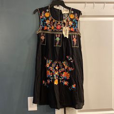 Savanna Jane Embroidered Boho Dress Nwt, Size Small, Black With Lining, Multi Colored Flower Embroidery To Front Length 34.5” Chest Width 18” Traditional Black Spring Dresses, Black Folk Embroidered Summer Dress, Black Cotton Folk Dress, Black Folk Style Cotton Dress, Black Folk Style Summer Dress, Black Folk Style Beach Dress, Black Dress With Geometric Embroidery For Spring, Black Bohemian Embroidered Mini Dress, Black Embroidered Dress With Geometric Patterns For Spring