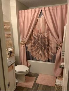 a bathroom with a shower curtain, toilet and bathtub in the middle of it