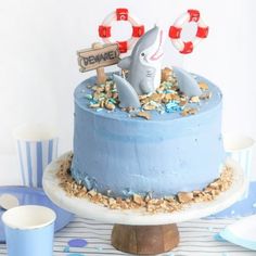 there is a blue cake with a shark on top and some candy in the middle