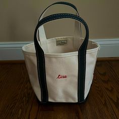 Brand New, Never Used, Perfect Condition! “Lisa” Is Embroidered In Red Thread. Canvas Is Ivory With Black Trim. Llbean Retails For $30 + $8 Monogramming + Shipping And Tax.Size Small Llbean Tote Bag Monogram, Ll Bean Tote, Boat And Tote, Boat Tote, Red Thread, Bean Bags, Small Canvas, Black Trim, Ll Bean