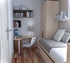 a small bedroom with a bed, desk and bookshelf