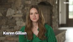 a woman standing in front of a stone wall with the words karren gill on it