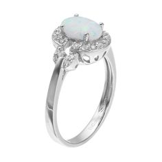 Adorned with a captivating lab-created white opal center stone, and white topaz accents, this sterling silver halo ring beautifully enhances your attire.RING DETAILSWidth: 10.92 mmMetal: sterling silverPlating: rhodiumFinish: polishedPackaging: boxedSTONE DETAILSStone type: lab-created white opal, white topazTotal weight: 1 1/4 ct.Center stone size: 8 mm x 6 mmShape: oval, roundSetting: prongGemstones may have been treated to enhance their appearance. Special care may be required. Please visit o White Oval Cabochon Promise Ring, White Oval Opal Ring For Formal Occasions, Classic White Opal Ring With Birthstone, Classic White Opal Birthstone Ring, White Opal Oval Cabochon Ring For Anniversary, White Opal Promise Ring Oval Cabochon, Oval Opal Birthstone Ring For Formal Occasions, White Oval Cabochon Opal Ring For Anniversary, White Opal Ring With Halo, Fine Jewelry