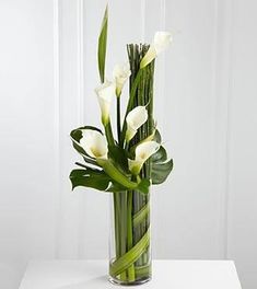 a vase filled with white flowers on top of a table