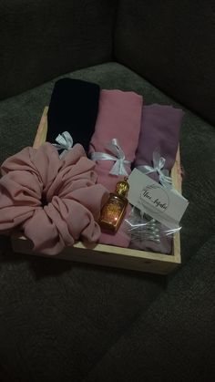 the gift box is filled with pink, blue and black items