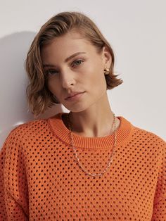 Upgrade your wardrobe with the Hester Knit Crewneck Sweater. This timeless piece features a bright orange hue, classic fit, and an oversized ribbed waistband for added style. The open knit design adds versatility, making it the perfect choice to pair with jeans or joggers. Elevate your style game with this must-have sweater. How To Hem Pants, Pleated Pants, Knit Crewneck, Open Knit, Sweaters Knitwear, Crewneck Sweater, Small Tops, Bright Orange, Knitting Designs