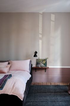 a bed sitting in a bedroom next to a window