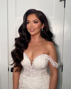 a woman in a wedding dress posing for the camera