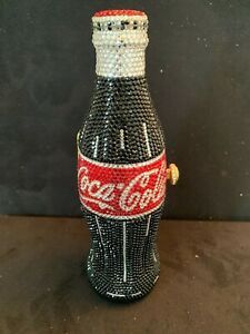 a coca - cola bottle is decorated with beads