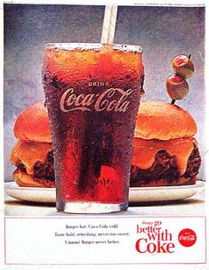 an advertisement for coca cola with a hamburger and a drink