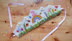 a piece of felt is laying on the floor with confetti and sprinkles around it