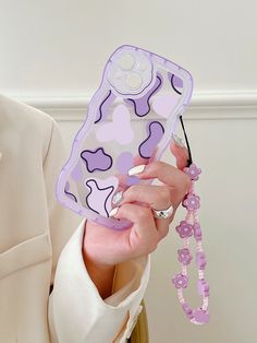 a woman holding up a cell phone case