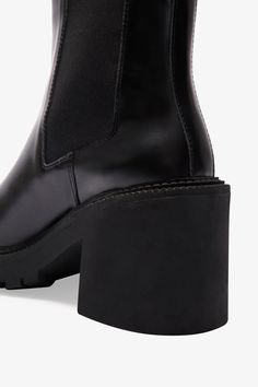 FINAL SALE - NO RETURNS, EXCHANGES, OR STORE CREDITOur Nostrand Lug Sole Boots are the essential chunky ankle boots ready to amplify every outfit in your rotation. Handcrafted from luxe and shiny Italian spazzolato leather, they feature a lug sole, a thick block heel, and a cap toe. Inspired by the Chelsea boot silhouette, they also feature an elastic side panel, making them that much more comfortable AND stylish for day-to-night wear. Shop Nostrand's sister style, Vex, for a mid-calf boot alter Trendy Ankle Boots With Lug Sole, Trendy Ankle Heeled Boots With Lug Sole, Trendy Heeled Boots With Lug Sole And Block Heel, Trendy Lug Sole Boots For Work, Trendy Heeled Boots With Lug Sole In Medium Width, Trendy Chelsea Boots With Reinforced Heel For Work, Block Heel Heeled Boots With Lug Sole For Work, High Heel Platform Boots With Lug Sole For Work, Modern Ankle Boots With Lug Sole