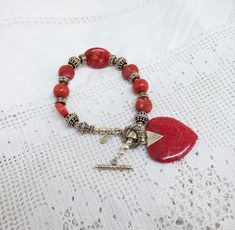 Solid Silver & Red Coral Bead Bracelet Toggle Catch Red Coral Heart Drop By The Designer Doug Paulus For QVC English Silver Import Marks. A beautiful bracelet the centre has an oval coral bead with silver beads and round coral beads the catch is a toggle and has a large coral drop heart. The silver is marked for Doug Paulus 925 and silver import marks for QVC. I have tested the Coral. The bracelet measures 8 inches long the heart drop measures 1 and a 1/4 inches long x 1 and 1/8th inches wide the length does not include the large chain bail. The bracelet is in very good condition. Any questions please ask. Thanks For Looking. Red Bracelets With Heart Beads, Red Beaded Heart Bracelet As Gift, Gift Red Beaded Heart Bracelet, Elegant Red Beaded Bracelets With Heart Beads, Red Adjustable Charm Bracelet With Heart Charm, Adjustable Red Charm Bracelet With Heart Charm, Red Adjustable Jewelry With Heart Beads, Adjustable Red Jewelry With Heart Beads, Red Beaded Charm Bracelet For Valentine's Day