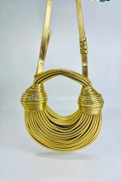 Elevate your accessory game with the luxurious "Gold Serpentine Rope Hobo #Handbag." This stunning handbag is crafted with intricate rope detailing that creates a serpentine effect, exuding #elegance and sophistication. The shimmering gold finish adds a touch of #glamour, making it the perfect statement piece for any outfit. Ideal for both day and night, this versatile hobo handbag is spacious enough to carry all your essentials while maintaining a chic and stylish look. Pair it with your favorite dress or casual ensemble to shine at every occasion. Belt Ring, Casual Beach Wear, Gold Palette, Screen Color, Hobo Handbag, Gold Handbags, Photography Lighting, Color Calibration, Hobo Handbags