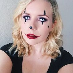 a woman with makeup on her face and nose is posing for the camera while wearing a black shirt