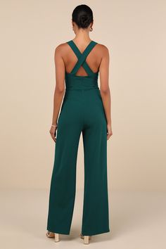 Everyone will admire your devotion to always looking sensational when they see you in the Lulus Glamorous Dedication Dark Green Sleeveless Wide-Length Jumpsuit! Stay sultry and comfortable all night with the stretchy crepe knit composition of this flirty jumpsuit that features a sleeveless bodice, a trendy square neckline, and wide straps that crisscross at the back. The high, fitted waist tops trendy wide pant legs that finish at full-length hems. Hidden back zipper/clasp. Fit: This garment fit Green Strapless Sleeveless Jumpsuit For Night Out, Elegant Green Backless Jumpsuit, Elegant Green Backless Jumpsuits And Rompers, Green Stretch Strapless Jumpsuit, Sleeveless Jumpsuits And Rompers For Night Out, Elegant Sleeveless Green Jumpsuit, Elegant Sleeveless Jumpsuit With Back Opening, Formal Sleeveless Jumpsuit With Back Opening, Formal Sleeveless Jumpsuits And Rompers With Back Opening