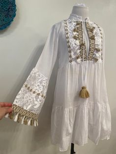 A white boho style mini dress tunic with tassel and lace details great for beach, pool, yachting and comfortable outfit FABRIC : 100%cotton sizes size 36 bust :85 cm size 38 bust: 89 cm size 40 bust:93cm size 42 bust ;97cm Cotton Long Sleeve Dress For Beach Season, Long Sleeve Cotton Dress For Beach Season, Bohemian Long Sleeve Fringe Cover-up, Long Sleeve Mini Dress For Beach Vacation, White Long Sleeve Mini Dress For Beach Season, Spring Beach Tunic With Long Sleeves, Long Sleeve Beach Tunic For Spring, Bohemian Long Sleeve Beach Dress For Brunch, Long Sleeve Mini Dress For Summer Beach Cover-up