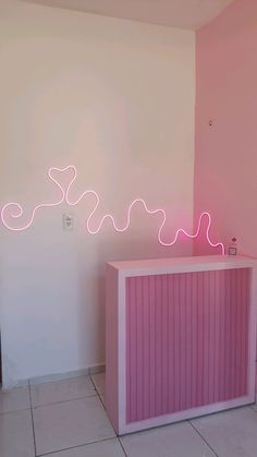 a pink bar with neon lights on the wall behind it in a room that has white tile flooring