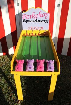 three little pigs are sitting on top of a bench in front of a carnival sign