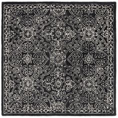 a black and white rug with an intricate design