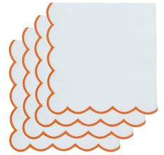 four white and orange placemats with scalloped edges