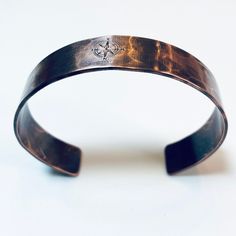 "Our copper cuff is hand forged and given a hammered finish.  The image of a compass is engraved on the outside  and the words \"You are my true north\" are stamped inside. The cuff is oxidized in an organic solution to give it a rich, warm patina and bring out the details. This is a beautiful everyday piece. Copper is also the traditional gift for the 7th and 22nd anniversary. *SIZING* The circumference of each cuff is the size in inches plus a 1.25\" to 1.5\" gap. To get the size measure the w Stamped Bronze Bracelets As Gifts, Stamped Bronze Bracelets For Gift, Bronze Stamped Bracelet For Gift, Gift Bronze Stamped Bracelets, Bronze Hand Forged Cuff Bracelet As Gift, Hand Forged Bronze Cuff Bracelet For Gift, Bronze Hand Forged Cuff Bracelet Gift, Hand Forged Bronze Cuff Bracelet Gift, Traditional Copper Bracelet Gift