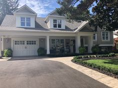 a large house with two car garages in the driveway