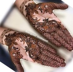 two hands with henna designs on them