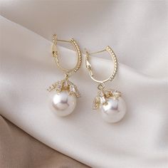 Pearls are the ultimate symbol of sophistication, beauty, and class. Instantly elevate any outfit with these stunning Malia Pearl Drop Earrings. Copper plated Cubic zirconia crystals, simulated pearl Size: 1.8in x 0.6in Latch back closure Hypoallergenic, lead & nickel free If you aren't in LOVE with your purchase, please let us know within 30 days of receiving your item, and you'll receive a stress-free refund. Large Statement Earrings, Hypoallergenic Jewelry, Huggie Earrings, Jewelry Manufacturers, Stylish Jewelry, Pearl Size, Pearl Drop Earrings, Crystal Rings, Pearl Drop