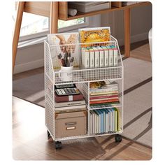 a white shelf with many books and magazines on it in a room next to a chair