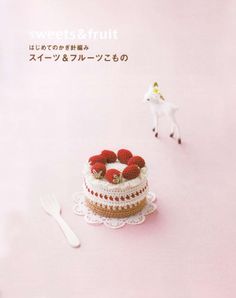 there is a cake with strawberries on it and a horse figurine next to it