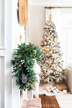 a decorated christmas tree in the corner of a living room