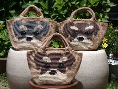 three woven purses sitting next to each other on top of a potted plant