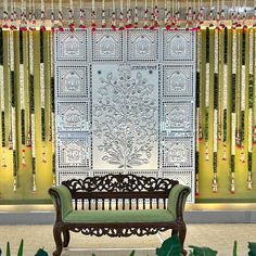 a wooden bench sitting in front of a window covered with curtains and beads hanging from the ceiling