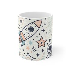 a coffee mug with an image of a rocket ship and stars on it